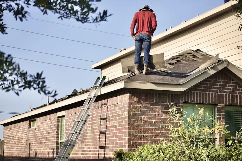 Professional roofer working on a residential roof in St. Louis